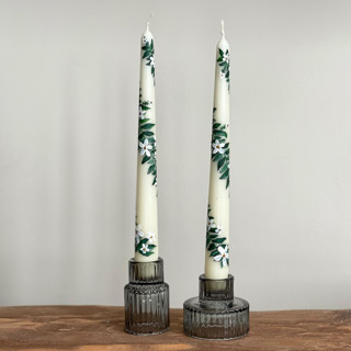 This is a beige wedding decor by Ashley Myers called Ivory with Greenery and White Floral Hand-Painted Taper Candles, Set of 2 in standard.