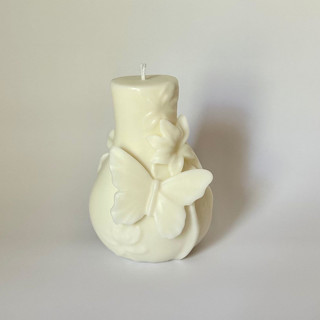 This is a white wedding candles by Over By The Moon called white butterfly and flower candle in standard