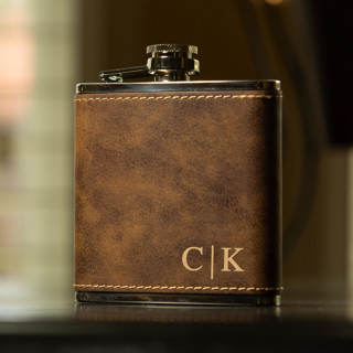 This is a brown groomsmen gifts by Great Little Favor Co called custom engraved rustic brown flask in standard