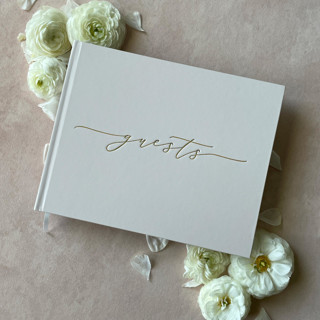 This is a white guest books by Barbara Gregory called ivory minimalist guest book in standard