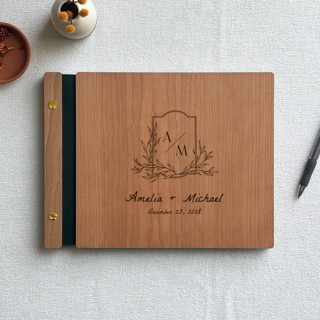 This is a brown guest books by Katrina Mejia called laurel crest wedding guest book | cherry wood | 8.5 x 11 in standard