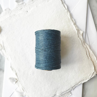 This is a blue wedding ribbon by Jenny Sanders called slate blue waxed linen twine, 4-ply in standard