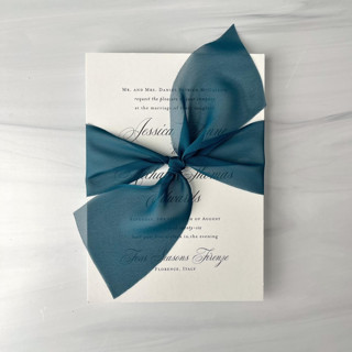 This is a blue wedding ribbon by Honey Silks Co called 2" signature sheer ribbon - deep teal in standard