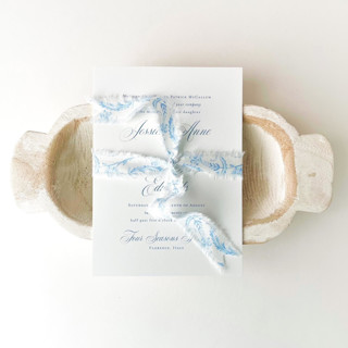 This is a blue wedding ribbon by Honey Silks Co called 1" cotton ribbon - floral blue in standard