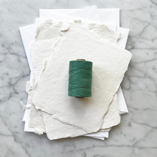 This is a green wedding ribbon by Jenny Sanders called sea green waxed linen twine, 2-ply in standard