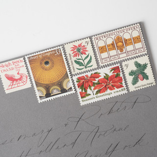 This is a red stamps by Flourish Fine Writing called christmas in the city vintage postage set // set of 5 // unused // gold & red // sleigh in standard