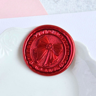 This is a multicolor wax seals by Inkspiringletters called bows and ruffles- customizable color- set of 25  hand- crafted wax seals in standard