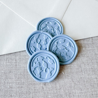 This is a blue wax seals by Maria Ferrer G. called dusty blue graduation wax seal - graduation cap throw | set of 10 in standard