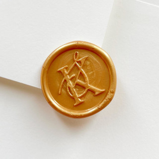 This is a gold wax seals by Self Stationery called custom monogram wax seal stickers for invitations & envelopes, 21 colors, set of 10 in standard