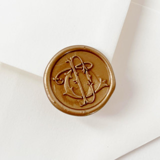 This is a gold wax seals by Self Stationery called monogram wax seal stickers | custom color & initials | self-adhesive | set of 10 in standard