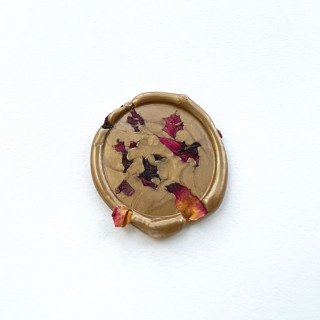 This is a gold wax seals by Caitlin Home called rose confetti wax seal in gold | pack of 10 in standard