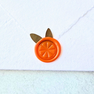 This is a orange wax seals by Inkspiringletters called orange slice- orange wax seal with dried botanicals- set of 25 hand-crafted wax seals in standard