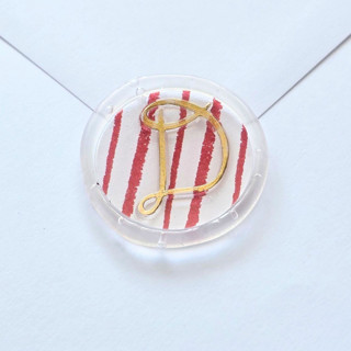 This is a clear wax seals by Inkspiringletters called striped playful cursive monogram- customizable- set of 25 hand-crafted  clear wax seals in standard