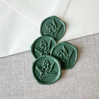 This is a green wax seals by Maria Ferrer G. called olive green lily of the valley 3d wax seal stickers | set of 10 in standard