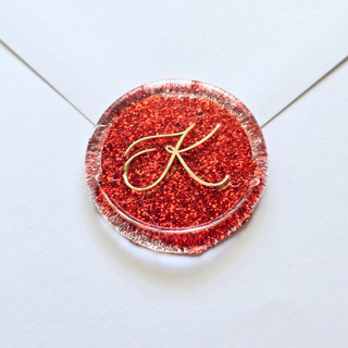 This is a red wax seals by Inkspiringletters called glitter script monogram- customizable- set of 25 hand-crafted red wax seals in standard