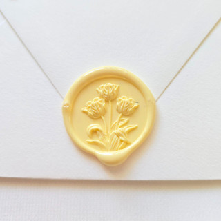 This is a multicolor wax seals by Inkspiringletters called tulips- customizable color- set of 25  hand-crafted wax seals in standard