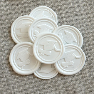 This is a white wax seals by Maria Ferrer G. called white graduation wax seal stickers - set of 10 in standard