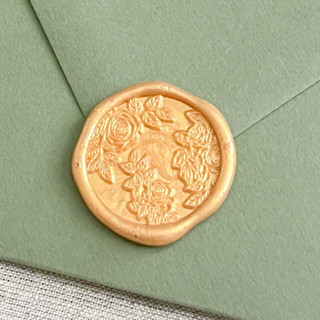 This is a gold wax seals by Maria Ferrer G. called roses self-adhesive wax seals in yellow gold | set of 10 in standard