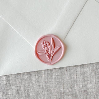 This is a pink wax seals by Maria Ferrer G. called dusty rose lily of the valley 3d wax seal stickers | set of 10 in standard