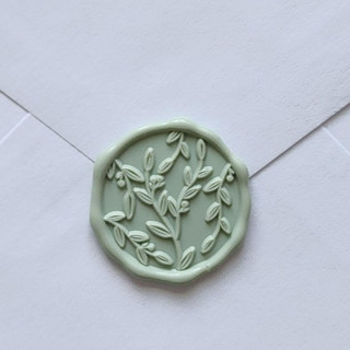 This is a green wax seals by MC silverlinings called customizable color vine leaves self-adhesive wax seals, set of 5 in standard