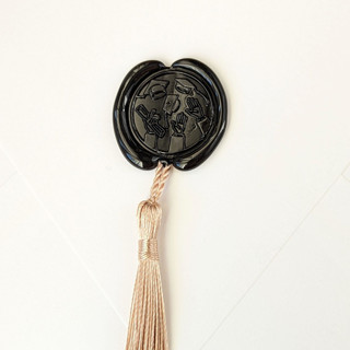 This is a multicolor wax seals by Inkspiringletters called hat toss- customizable wax color- set of 25 hand-crafted wax seals with gold tassels in standard