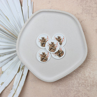This is a brown wax seals by Clove and Cedar Design called pinecone with berries wax seals for holiday cards and wedding invites | set of 25 in standard
