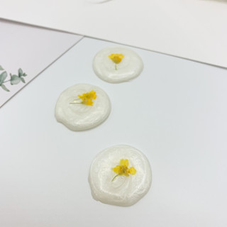 This is a white wax seals by Christine OMalley called pressed flower ivory wax seal yellow flower set of 6 in standard