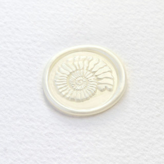 This is a multicolor wax seals by Inkspiringletters called spiral seashell- customizable color- set of 25 hand-crafted wax seals in standard