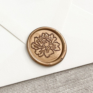 This is a bronze wax seals by Orchid Studio called peony self-adhesive wax seals in antique gold | set of 10 in standard