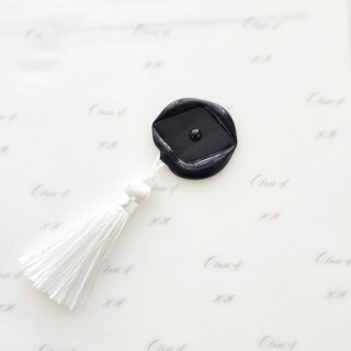 This is a multicolor wax seals by Inkspiringletters called grad cap with mini white tassel- hand-crafted wax seals - set of 25- customizable color in standard
