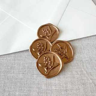 This is a gold wax seals by Orchid Studio called antique gold lily of the valley 3d wax seal stickers | set of 10 in standard
