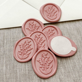 This is a pink wax seals by Maria Ferrer G. called lily of the valley oval wax seal stickers in dusty rose | set of 10 in standard