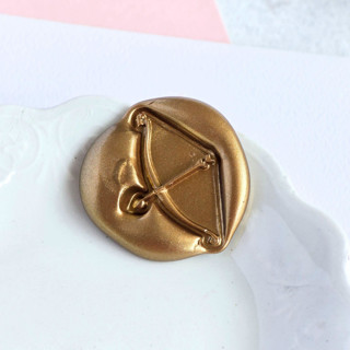 This is a multicolor wax seals by Inkspiringletters called cupid's arrow- customizable color- set of 25 hand-crafted wax seals in standard