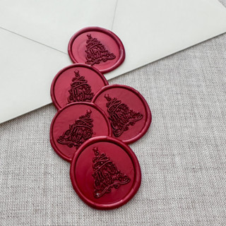 This is a red wax seals by Maria Ferrer G. called metallic red "merry christmas" tree calligraphy wax seal sticker | set of 10 in standard