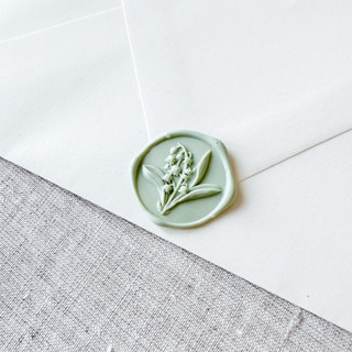 This is a green wax seals by Orchid Studio called sage green lily of the valley 3d wax seal stickers | set of 10 in standard