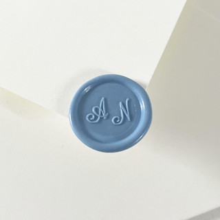 This is a blue wax seals by Self Stationery called personalized self adhesive wax seal stickers, custom color | set of 10 in standard