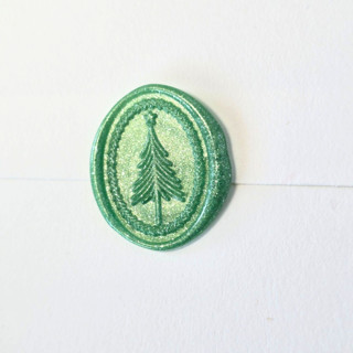 This is a green wax seals by Inkspiringletters called minimalist xmas tree- limited edition- set of 12 hand-crafted wax seals in standard