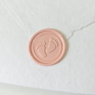 This is a multicolor wax seals by Inkspiringletters called baby feet- customizable color- set of 25 hand-crafted wax seals in standard