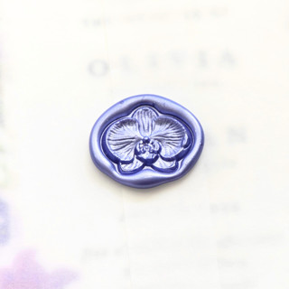 This is a multicolor wax seals by Inkspiringletters called cattleya orchid -hand-crafted wax seals - customizable color- set of 25 in standard