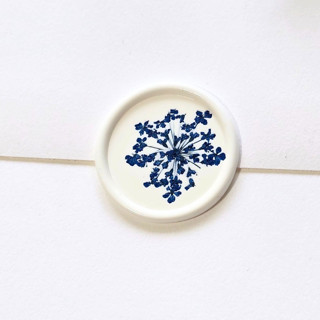 This is a multicolor wax seals by Inkspiringletters called queen anne's lace- blue dried and pressed florals on white - customizable shape- set of 25 wax seals in standard