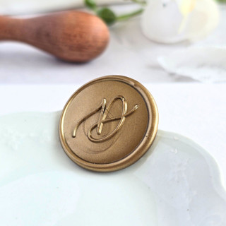 This is a multicolor wax seals by Inkspiringletters called script monogram- customizable color- set of 25 hand-crafted wax seals in standard