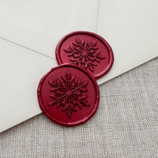 This is a red wax seals by Maria Ferrer G. called metallic red christmas snowflake wax seal sticker | set of 10 in standard