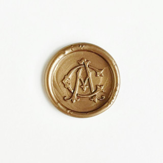 This is a gold wax seals by Self Stationery called personalized monogram wax seal sticker, custom color & initials, self-adhesive, set of 10 in standard