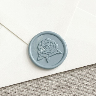 This is a blue wax seals by Maria Ferrer G. called rose self-adhesive wax seal in dusty blue | set of 10 in standard