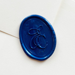 This is a blue wax seals by Self Stationery called personalized oval wax seal stickers | custom intertwined monogram | set of 10 in standard