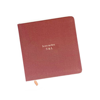 This is a brown journals by Jessica Cunningham called custom text foil embossed square linen notebook | gold foil on rust linen in standard
