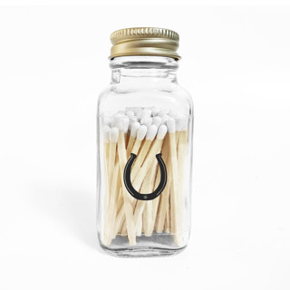 This is a gold journals by Jessica Cunningham called lucky horseshoe 2" white match jar in standard