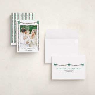 This is a pine holiday photo cards with standard by Susan Moyal called holly & bows printing on recycled smooth signature in grand