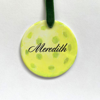 This is a yellow holiday decorations by Holly Whitcomb called personalized pickleball ceramic ornament in standard