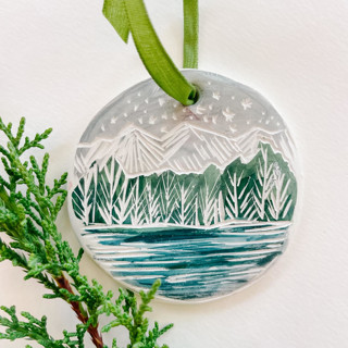 This is a green holiday decorations by Sarah Fitzgerald called winter mountain ornament no. 1 in standard